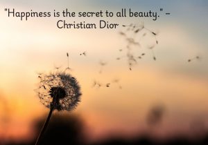 Happiness is the secret to all beauty" by Christian Dior suggests that true beauty comes from within, and a joyful spirit enhances one’s appearance. It emphasizes that happiness radiates outward, making a person more attractive and glowing in both their inner and outer self.